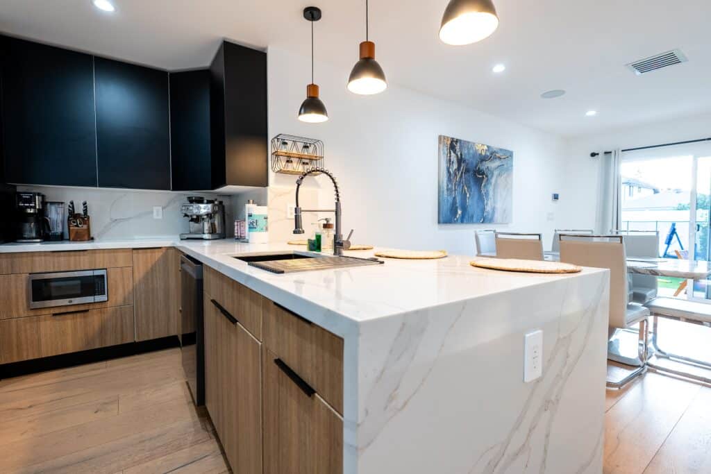 Remodeled kitchen with marble waterfall island and pendant lighting — Sunnyslope project, Sherman Oaks